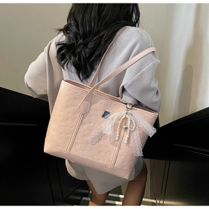 Pink tote bag detail with Sanrio-style embossed texture and lace bow pearl pendant