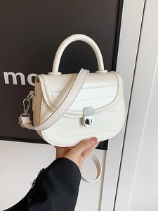 Chic cream white saddle handbag with textured finish and silver buckle for women