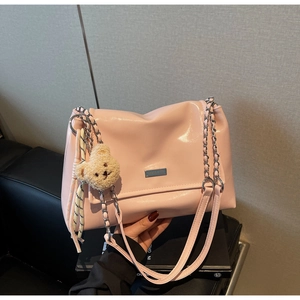 Pink glossy leather tote bag with silver chain strap and cute bear charm detail