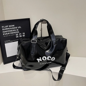 Detail of glossy black large-capacity travel bag with adjustable shoulder strap