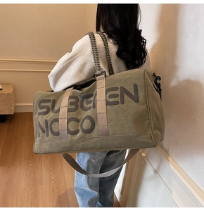 Detail of army green travel canvas bag with thick woven ropes and side printing