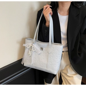 Light blue PU tote bag detail with cartoon embossing, lace bow, and pearl charm