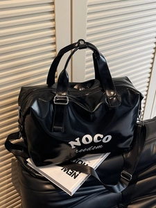 Glossy black large travel bag with NOCO freedom logo and adjustable strap