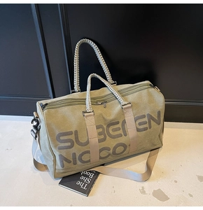 Olive green canvas travel bag detail featuring large graphic text and rope carry handles