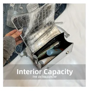 Internal view of silver croc-effect bag showing space for phone and makeup