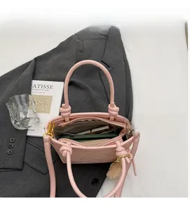 Detail view of pink bucket bag interior showing spacious capacity and inner zipper pocket