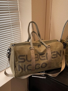 Large army green canvas travel bag with rope handles and Suberen Noco print