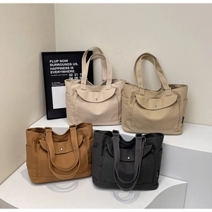 Detailed display of high-capacity canvas tote bags in white, khaki, brown, and grey
