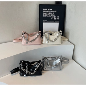 Close-up of stylish metallic underarm bags with thick silver chains in four colors