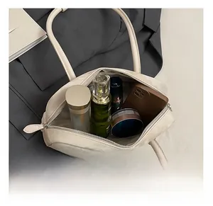 Detailed interior view of a cream leather tote bag showing spacious storage capacity