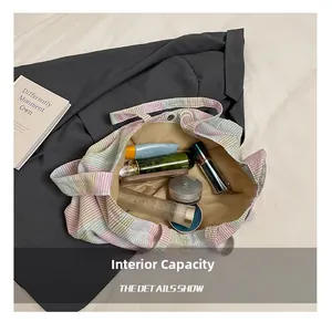 Detailed view of spacious interior of striped canvas tote bag with various cosmetics