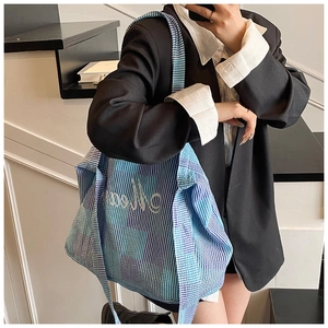 Mirror shot showing the large capacity and fit of the striped canvas tote bag on model