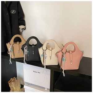 Selection of four bucket bags in brown, black, cream, and pink with silk scarves