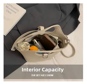 Interior view of beige litchi leather bucket bag showing large storage capacity