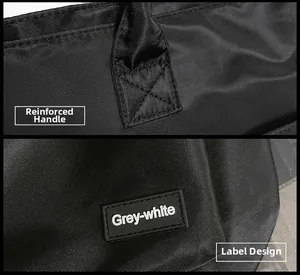 Detail of reinforced cross-stitching on nylon handles and minimalist black logo tag