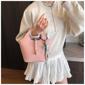 Pink lychee grain leather bucket bag with silver lock and candy pendant detail