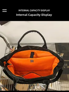 Detail of travel bag internal capacity with orange lining and padded laptop compartment