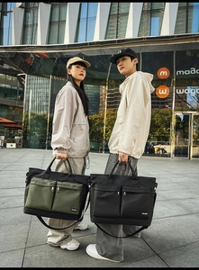 Detail of multi-pocket large travel bag featuring dual front zipper pouches for storage