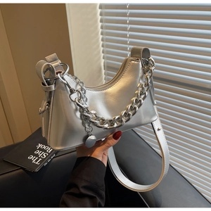 Detailed view of silver metallic shoulder bag with thick chain and wide strap