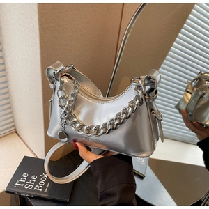 Detailed view of silver glossy hobo bag with chunky metal chain and embossed logo