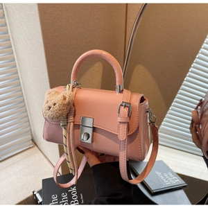 Pink PU leather square bag with top handle and a cute brown teddy bear charm detail