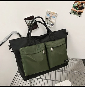 Detail view of large nylon travel tote bag with army green zip pockets on a metal rack