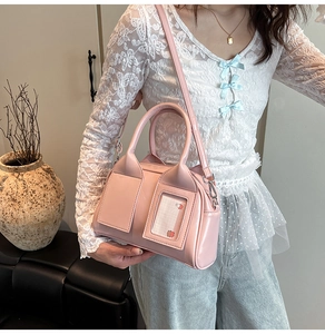 Detailed macro view of pink glossy patent leather handbag with clear front card slot detail