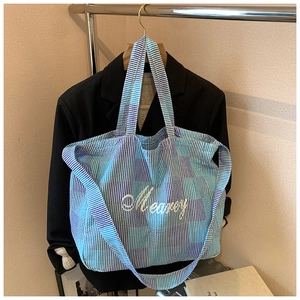 Detail of blue and purple plaid canvas tote bag with Meancy embroidery and wide strap