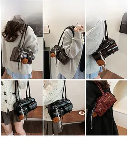 Close-up of vintage multi-pocket PU leather shoulder bags in black, brown and wine red