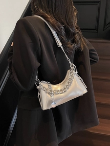 Silver glossy leather shoulder bag with metal chain strap and minimalist dumpling shape