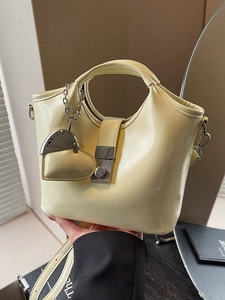 Chic cream yellow PU leather bucket bag with top handle and heart-shaped charm detail