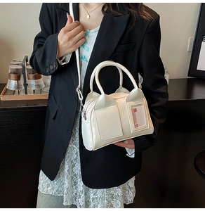 Detail view of cream patent leather pillow bag with cute bear card slot and silver hardware
