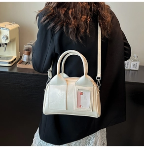 Macro detail of creamy leather bowling bag with transparent card slot and pink card