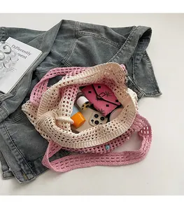 Detail of pink and beige crochet tote bag with pearl beads and spacious interior