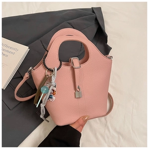 Pink lychee grain bucket bag featuring a unique hollow handle and metal padlock detail