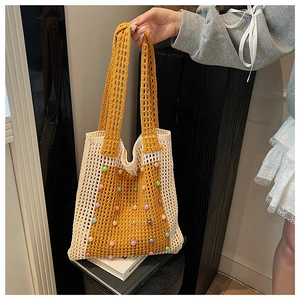 Detail of hand-crocheted hollow tote bag featuring colorful beads and ginger yellow contrast