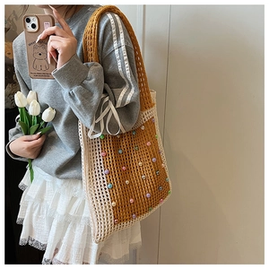 Detail of hand-crocheted tote bag with contrast colors and colorful bead decorations