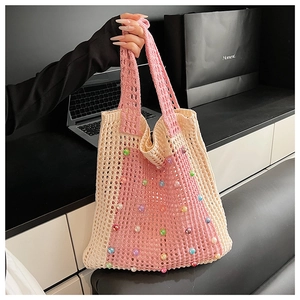 Detailed close-up of pink and cream crochet tote bag with colorful pearl accents