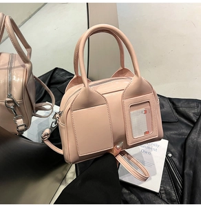 Detail of pink Boston bag with transparent card pocket on black leather jacket