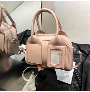 Close-up of pink Boston bag showing PU leather texture and front card slots with window