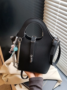 Minimalist black lychee leather bucket bag with silver hardware and cute charms