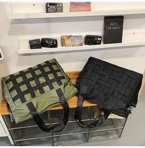 Detail of olive green and black nylon tote bags featuring industrial woven grid straps