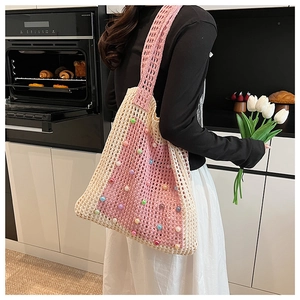 Detail of hand-crocheted hollow tote bag with colorful faux pearl beads and wide strap