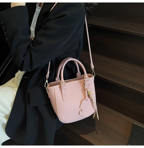 Pink pebbled leather bucket bag with cute bear pendant and detachable shoulder strap