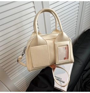 Close-up of off-white boston bag featuring decorative card slot with cartoon card insert