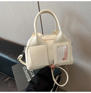 Detail of cream white Boston bag featuring dual front pockets and cute bear card holder