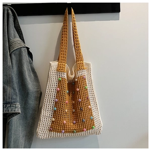 Detail of handwoven crochet tote bag featuring vibrant colorful beads and contrast panel
