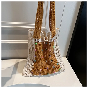 Close-up of crochet tote bag with colorful beads and textured knit pattern details