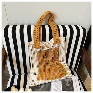 Detail of knit crochet tote bag with colorful beads and contrasting two-tone stitch