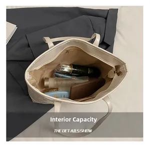 Detailed interior of the off-white leather tote bag showing spacious capacity and zipper pocket